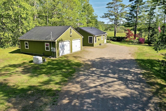 3 Reeds Ln, Belfast, ME 04915 - view of front facade featuring asphalt driveway, a garage, a front lawn, and metal roof