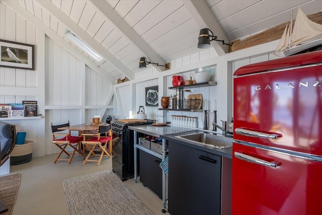 459 Main Rd, Islesboro, ME 04848 - kitchen with black range, freestanding refrigerator, wooden ceiling, and open shelves
