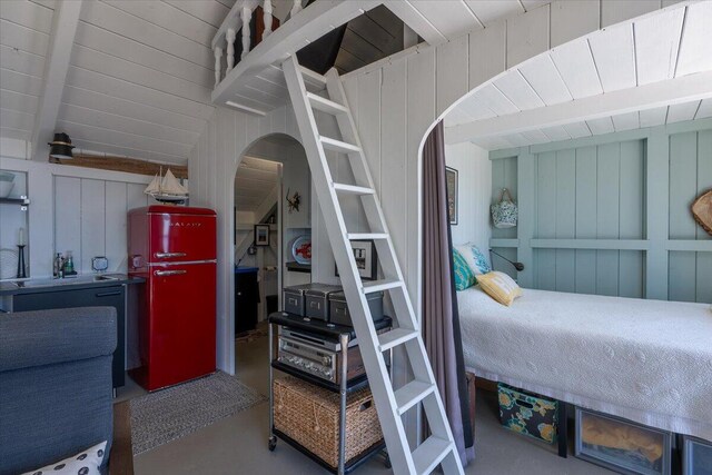 459 Main Rd, Islesboro, ME 04848 - bedroom featuring concrete floors, arched walkways, and lofted ceiling