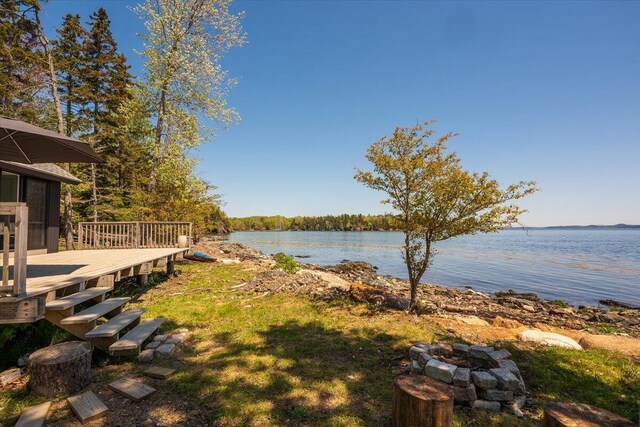 459 Main Rd, Islesboro, ME 04848 - view of yard featuring a deck with water view and a fire pit