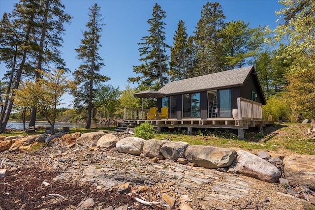 459 Main Rd, Islesboro, ME 04848 - view of front of home featuring a deck, roof with shingles, and a sunroom