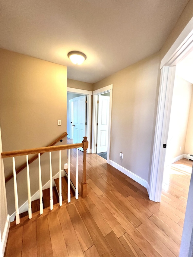 52 Peary Ter, South Portland, ME 04106 - stairway with wood-type flooring, baseboards, and a baseboard radiator