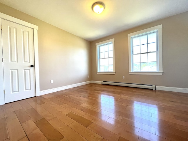 52 Peary Ter, South Portland, ME 04106 - spare room featuring a baseboard heating unit, hardwood / wood-style flooring, and baseboards