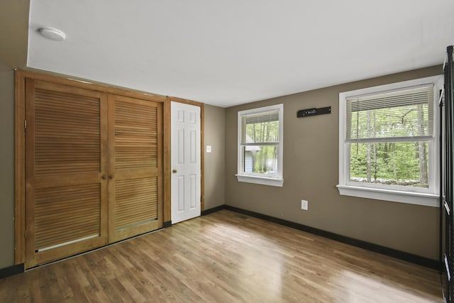 398 Hopper Rd, Acton, ME 04001 - unfurnished bedroom featuring wood finished floors, a closet, and baseboards