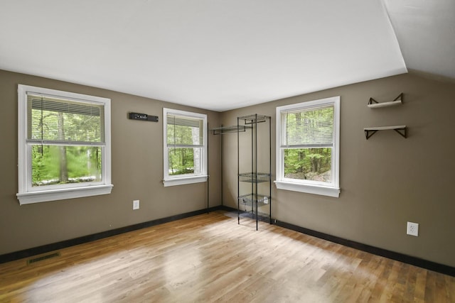 398 Hopper Rd, Acton, ME 04001 - unfurnished bedroom featuring wood finished floors, vaulted ceiling, and baseboards