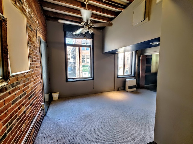 92-94 Main St, Auburn, ME 04210 - carpeted empty room with beam ceiling, brick wall, ceiling fan, and heating unit