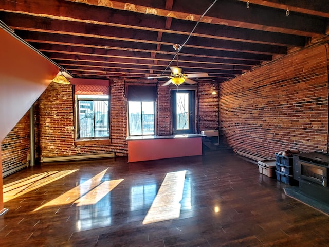 92-94 Main St, Auburn, ME 04210 - unfurnished living room featuring a wood stove, brick wall, wood finished floors, a ceiling fan, and beamed ceiling