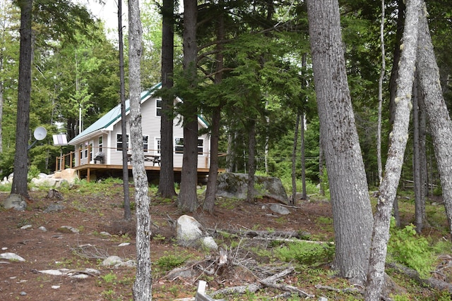 121 Loop Rd, Lincoln, ME 04457 - view of side of property with a deck and a wooded view
