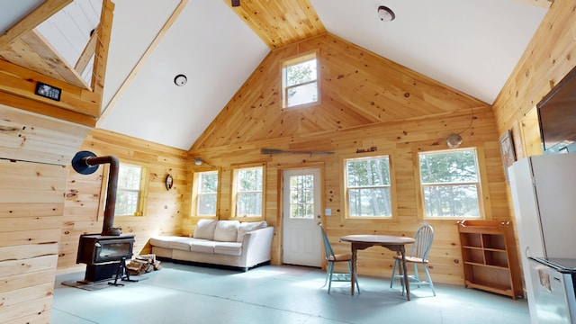 121 Loop Rd, Lincoln, ME 04457 - living area with wood walls, a wood stove, and high vaulted ceiling