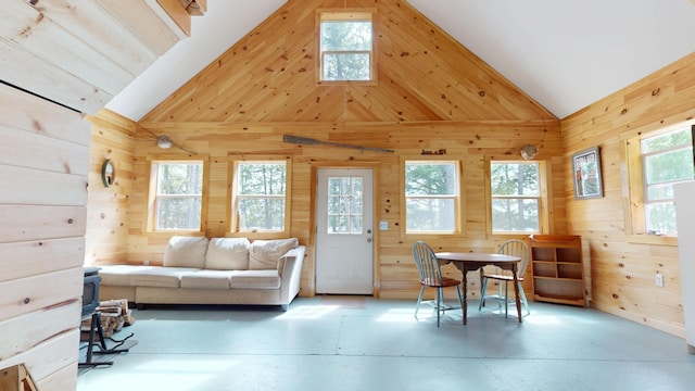 121 Loop Rd, Lincoln, ME 04457 - living area featuring vaulted ceiling, wood walls, and healthy amount of natural light