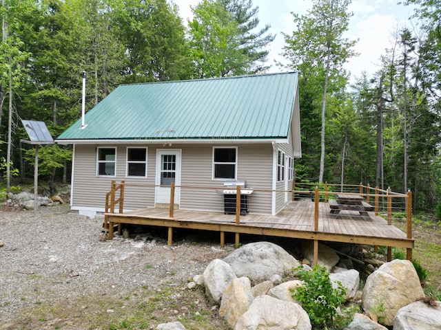 121 Loop Rd, Lincoln, ME 04457 - back of house with metal roof and a wooden deck