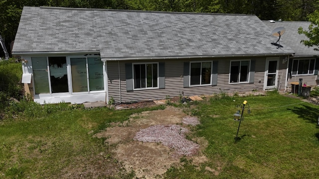422 Cross Rd, Swanville, ME 04915 - rear view of house featuring roof with shingles and a lawn