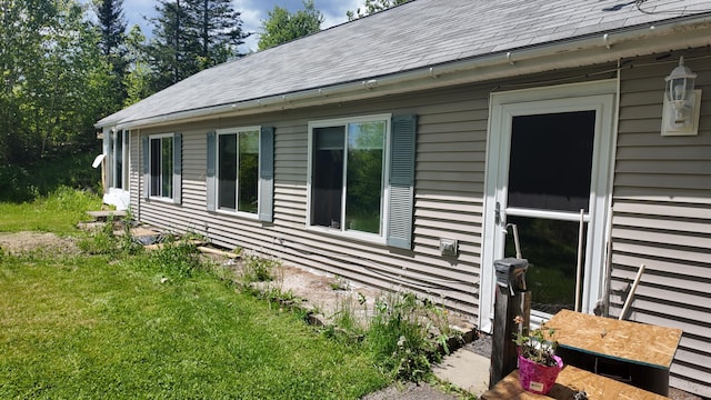 422 Cross Rd, Swanville, ME 04915 - view of property exterior with a shingled roof and a lawn