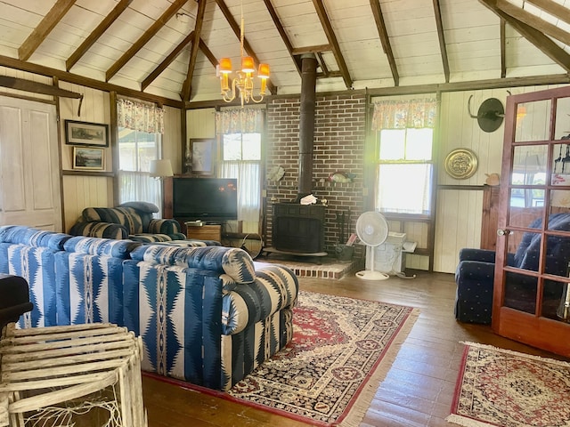 51 Rock Haven Dr, West Bath, ME 04530 - living room with hardwood / wood-style flooring, a chandelier, plenty of natural light, a wood stove, and wood walls