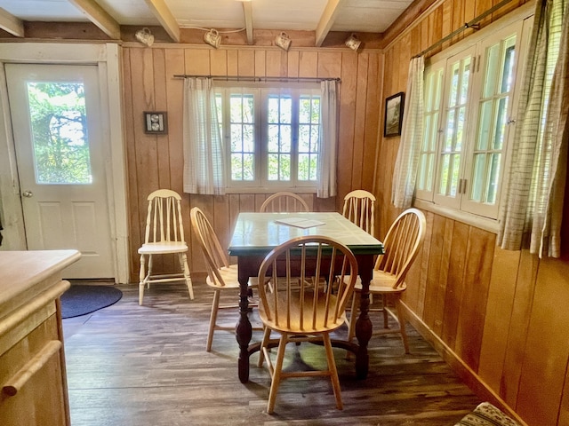 51 Rock Haven Dr, West Bath, ME 04530 - dining space with healthy amount of natural light, wood walls, beam ceiling, and wood finished floors