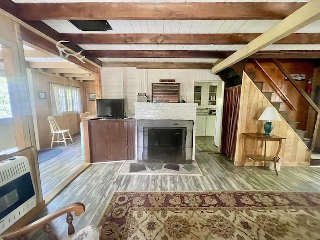 51 Rock Haven Dr, West Bath, ME 04530 - living room with heating unit, wood finished floors, beamed ceiling, wood walls, and stairs