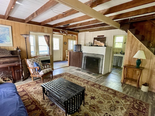 51 Rock Haven Dr, West Bath, ME 04530 - living room featuring wood walls, beamed ceiling, wood finished floors, and a fireplace