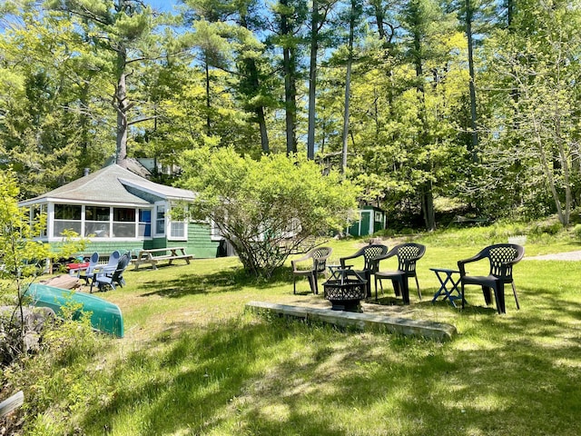 51 Rock Haven Dr, West Bath, ME 04530 - view of green lawn with a fire pit and a sunroom