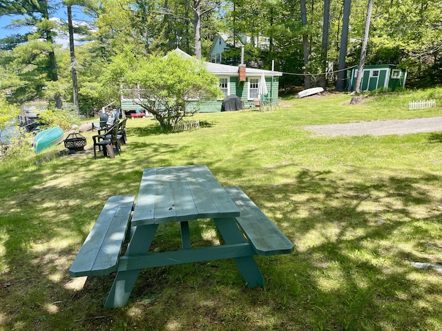51 Rock Haven Dr, West Bath, ME 04530 - view of property's community with a yard, an outdoor fire pit, and view of wooded area