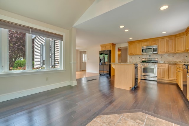 61 Carlyle Rd, Portland, ME 04103 - kitchen with appliances with stainless steel finishes, a center island, light brown cabinetry, backsplash, and dark wood-style flooring