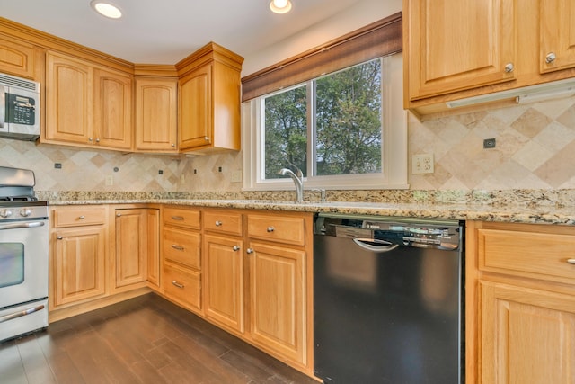 61 Carlyle Rd, Portland, ME 04103 - kitchen featuring appliances with stainless steel finishes, light stone countertops, a sink, dark wood-style floors, and recessed lighting