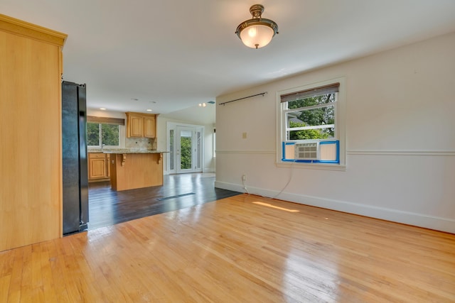 61 Carlyle Rd, Portland, ME 04103 - unfurnished living room featuring light wood-style flooring, baseboards, and healthy amount of natural light