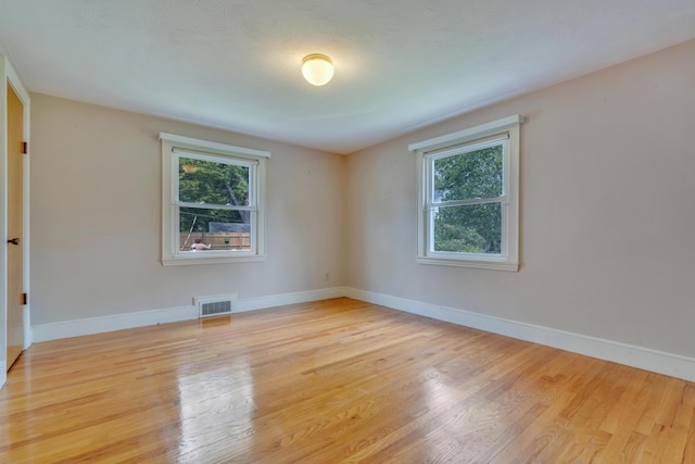 61 Carlyle Rd, Portland, ME 04103 - empty room featuring plenty of natural light, light wood finished floors, and baseboards