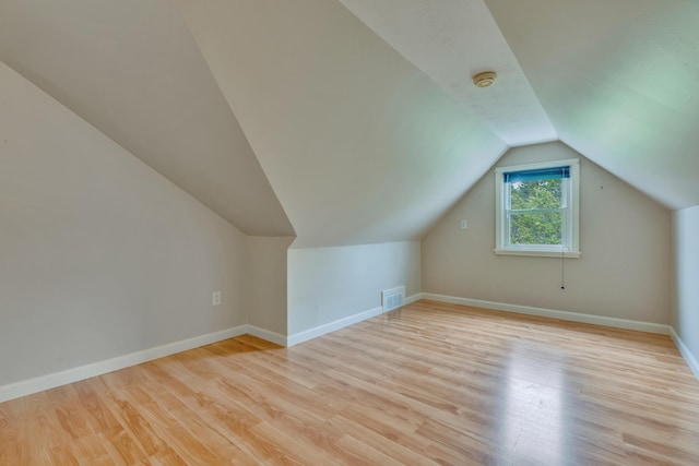 61 Carlyle Rd, Portland, ME 04103 - additional living space with light wood-style flooring, vaulted ceiling, and baseboards