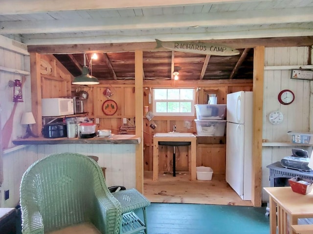 16 Mellen Ln, Wilton, ME 04294 - kitchen featuring white appliances, wood walls, hardwood / wood-style floors, and wood ceiling with exposed beams