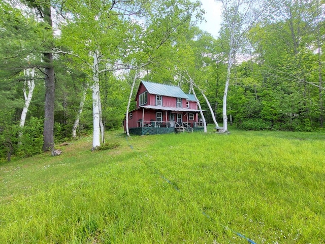 16 Mellen Ln, Wilton, ME 04294 - view of grassy yard with a wooded view and covered porch