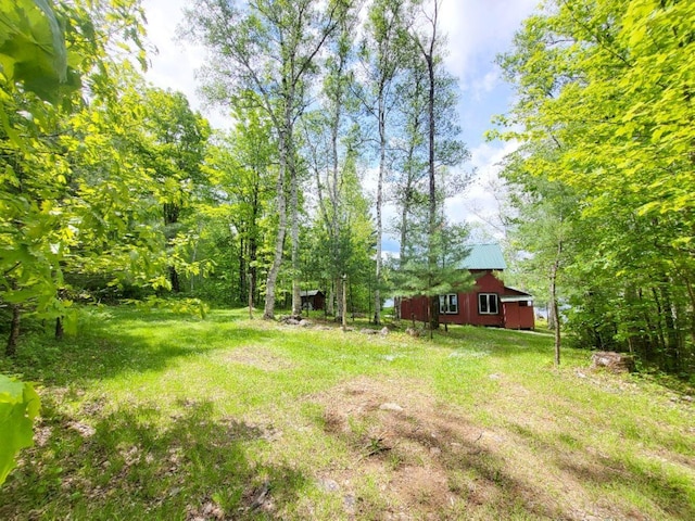 16 Mellen Ln, Wilton, ME 04294 - view of green lawn with a barn and an outbuilding