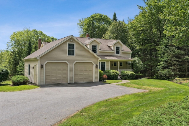 61 Crestview Ln, Brunswick, ME 04011 - view of front facade featuring a front yard, a garage, asphalt driveway, and a shingled roof