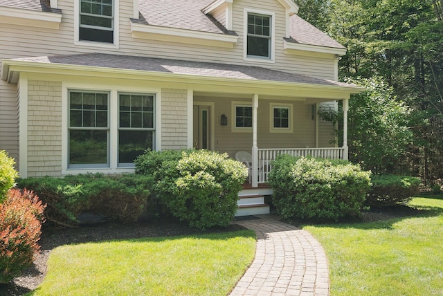 61 Crestview Ln, Brunswick, ME 04011 - view of front facade with roof with shingles, a front lawn, and covered porch