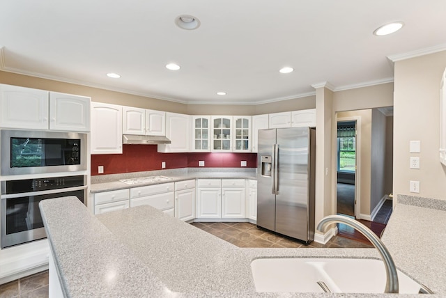 61 Crestview Ln, Brunswick, ME 04011 - kitchen featuring appliances with stainless steel finishes, under cabinet range hood, glass insert cabinets, white cabinetry, and crown molding