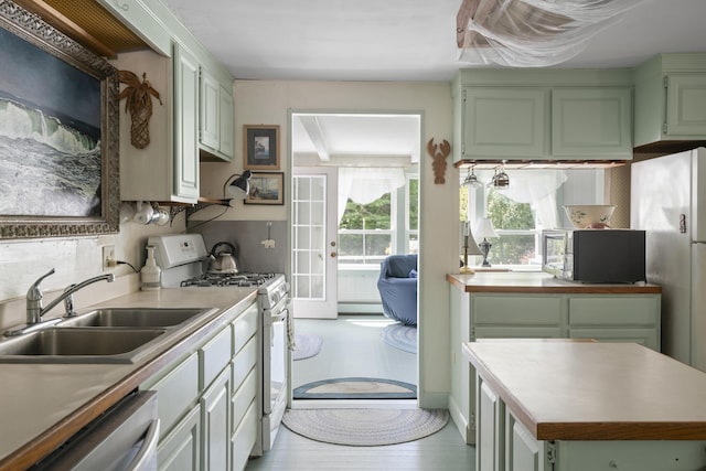 1241 Harpswell Islands Rd, Harpswell, ME 04079 - kitchen featuring appliances with stainless steel finishes, a sink, a baseboard heating unit, light countertops, and green cabinetry