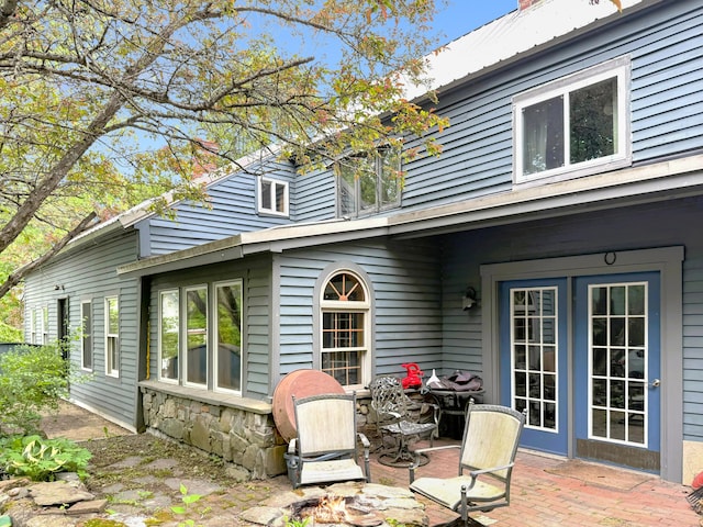 99 Kenduskeag Ave, Bangor, ME 04401 - rear view of house with an outdoor fire pit and a patio area