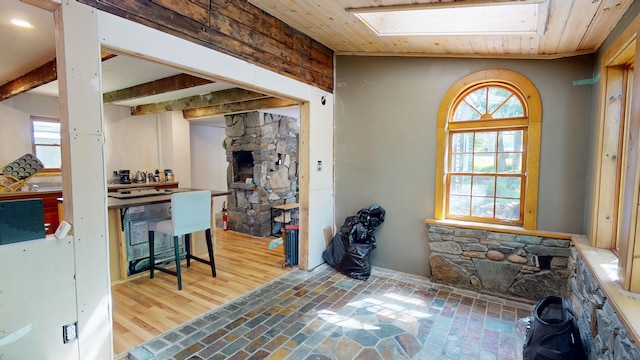 99 Kenduskeag Ave, Bangor, ME 04401 - kitchen featuring a skylight, a fireplace, and wooden ceiling