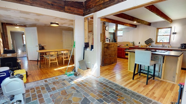 99 Kenduskeag Ave, Bangor, ME 04401 - kitchen featuring dishwasher, healthy amount of natural light, beam ceiling, a breakfast bar, and a sink
