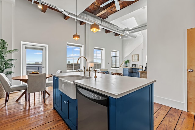 15 Brown St Unit 405, Portland, ME 04101 - kitchen with blue cabinets, dishwasher, a sink, a high ceiling, and open floor plan