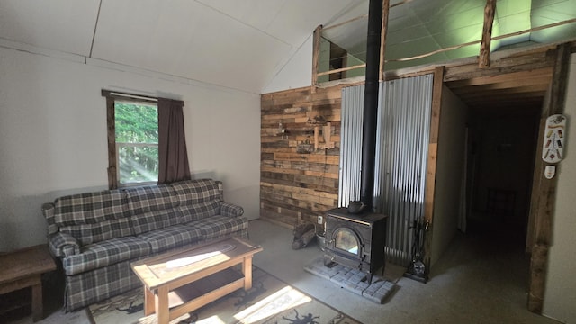 55.4AC Fire Rd, Linneus, ME 04730 - living area featuring lofted ceiling, a wood stove, and wood walls