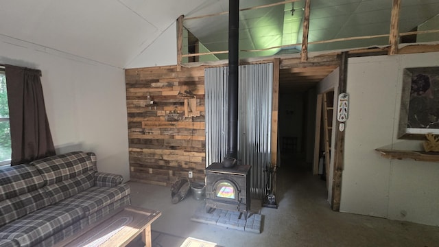 55.4AC Fire Rd, Linneus, ME 04730 - living area with lofted ceiling, a wood stove, and concrete flooring