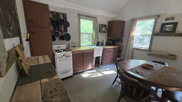 55.4AC Fire Rd, Linneus, ME 04730 - kitchen featuring white gas stove, lofted ceiling, and light countertops