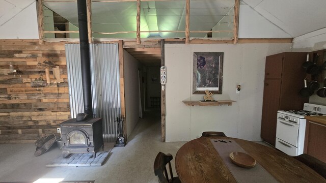 55.4AC Fire Rd, Linneus, ME 04730 - kitchen with white gas range, a wood stove, and concrete flooring