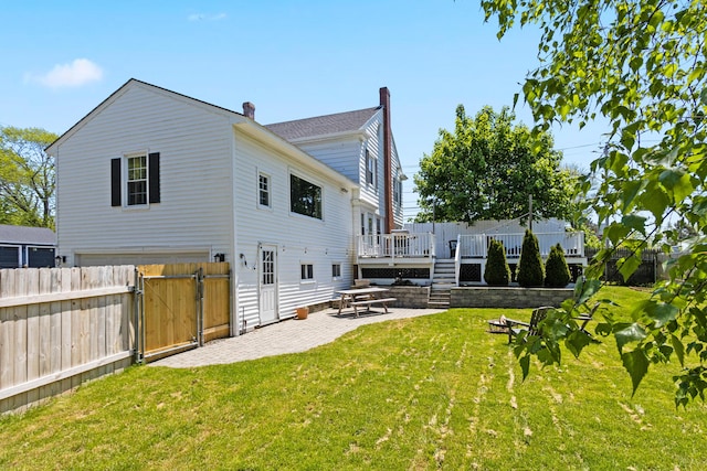 797 Main St, South Portland, ME 04106 - back of property with a patio, a gate, a deck, and a chimney