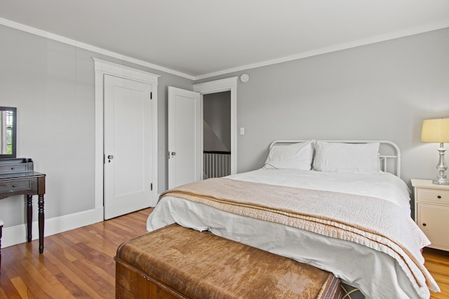 797 Main St, South Portland, ME 04106 - bedroom with wood finished floors, crown molding, baseboards, and a closet