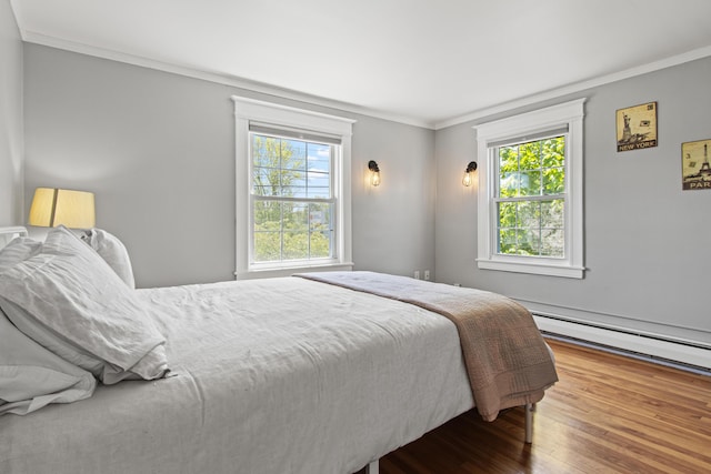 797 Main St, South Portland, ME 04106 - bedroom with ornamental molding, wood finished floors, and baseboard heating