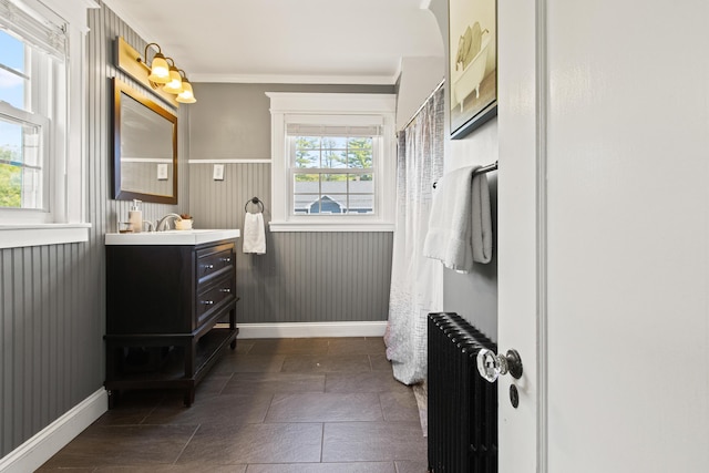 797 Main St, South Portland, ME 04106 - bathroom with radiator, vanity, wainscoting, baseboards, and crown molding