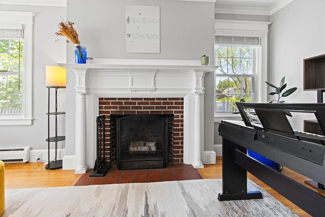 797 Main St, South Portland, ME 04106 - detailed view of a brick fireplace, ornamental molding, wood finished floors, and a baseboard heating unit