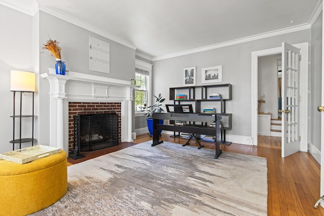 797 Main St, South Portland, ME 04106 - home office with wood-type flooring, a brick fireplace, crown molding, and baseboards