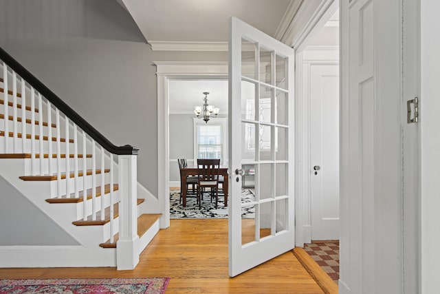 797 Main St, South Portland, ME 04106 - foyer featuring crown molding, light wood-type flooring, a chandelier, and stairway